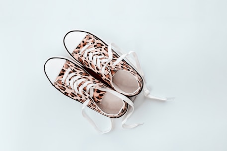 pair of brown-and-beige leopard print low-top sneakers