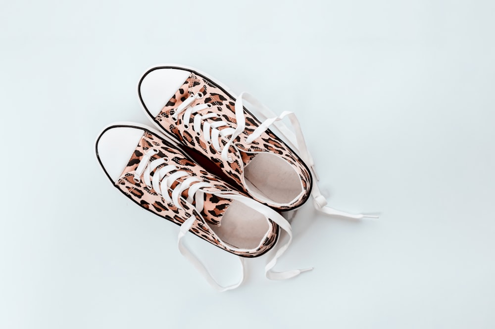 pair of brown-and-beige leopard print low-top sneakers