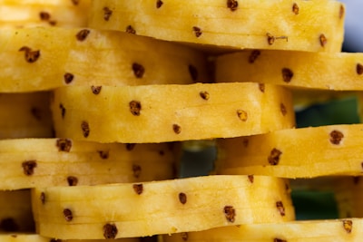 A close-up of canned pineapple slices sealed and stacked neatly, showcasing tropical sweetness.