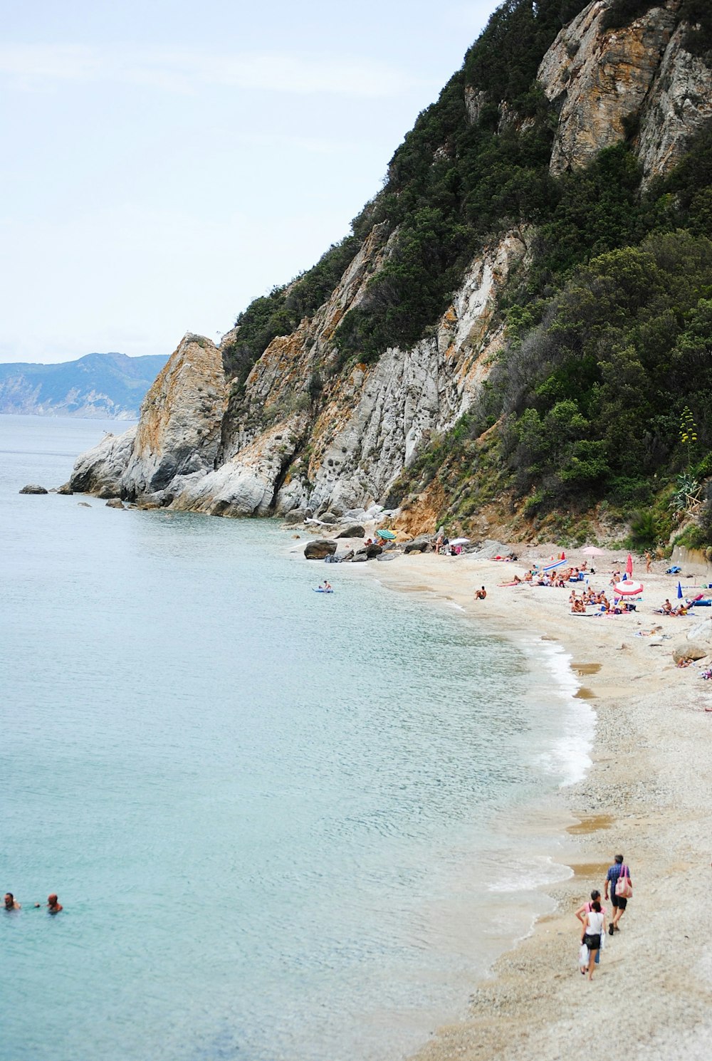 people walking on seashore