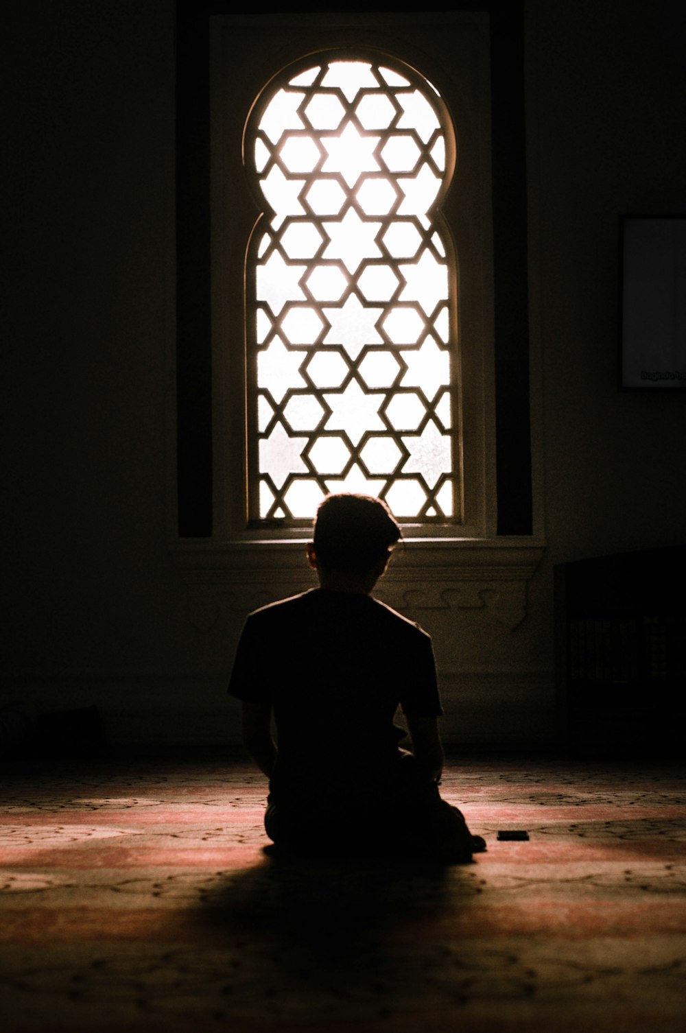 man standing in front of window