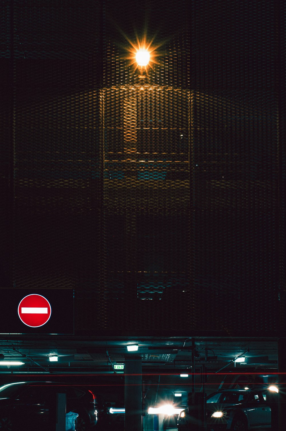 a red stop sign sitting under a street light