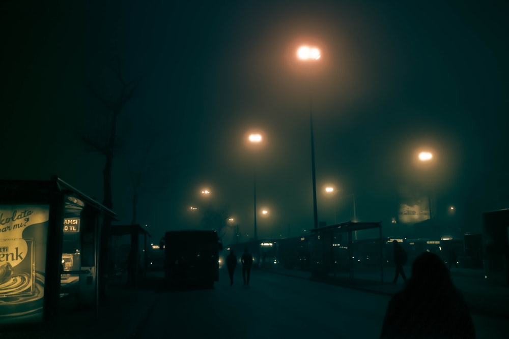 silhouette of people walking on street