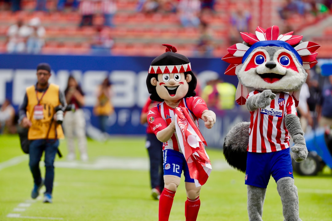 two mascots on field during daytime