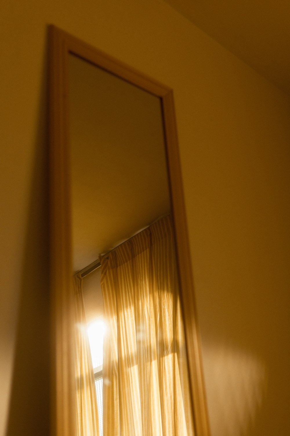 brown framed leaning mirror