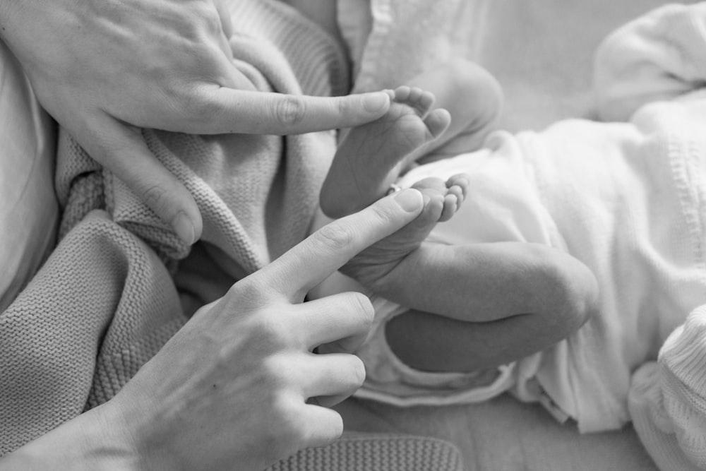 person holding baby's feet