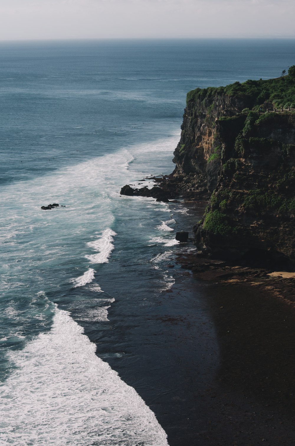 aerial photography of cliff beside body of water during daytime