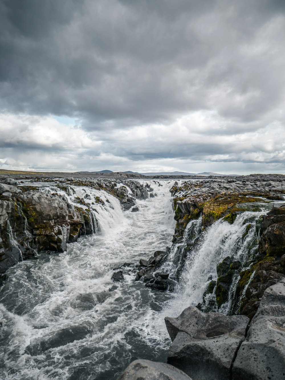 river under grey sky