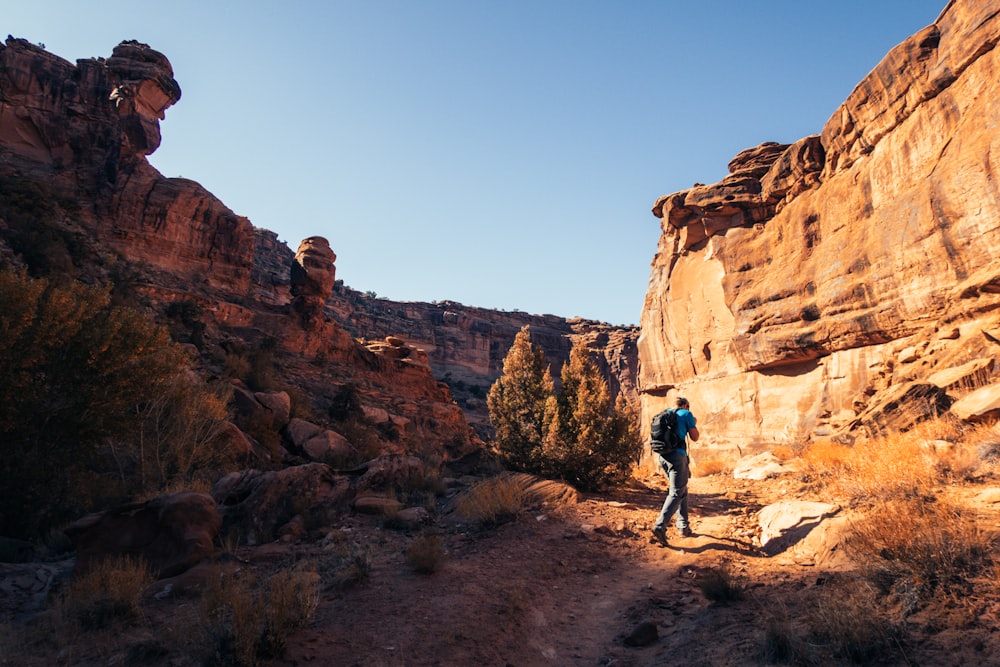 man walking on dirt pathway