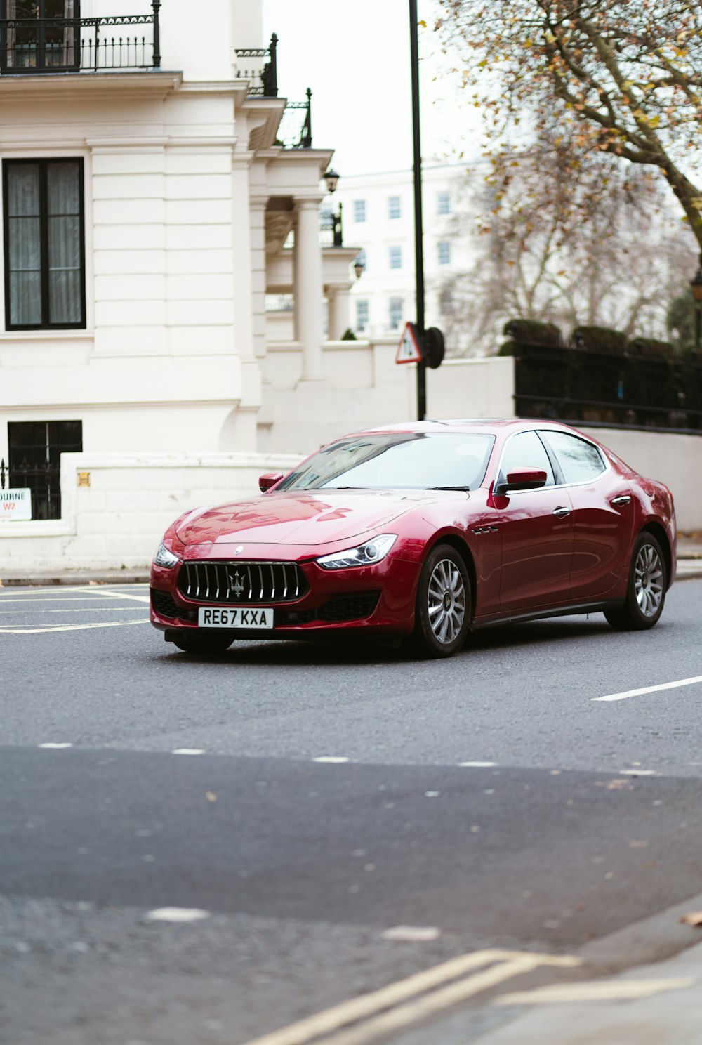 red sedan on paved road