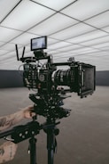 black professional video camera on stand