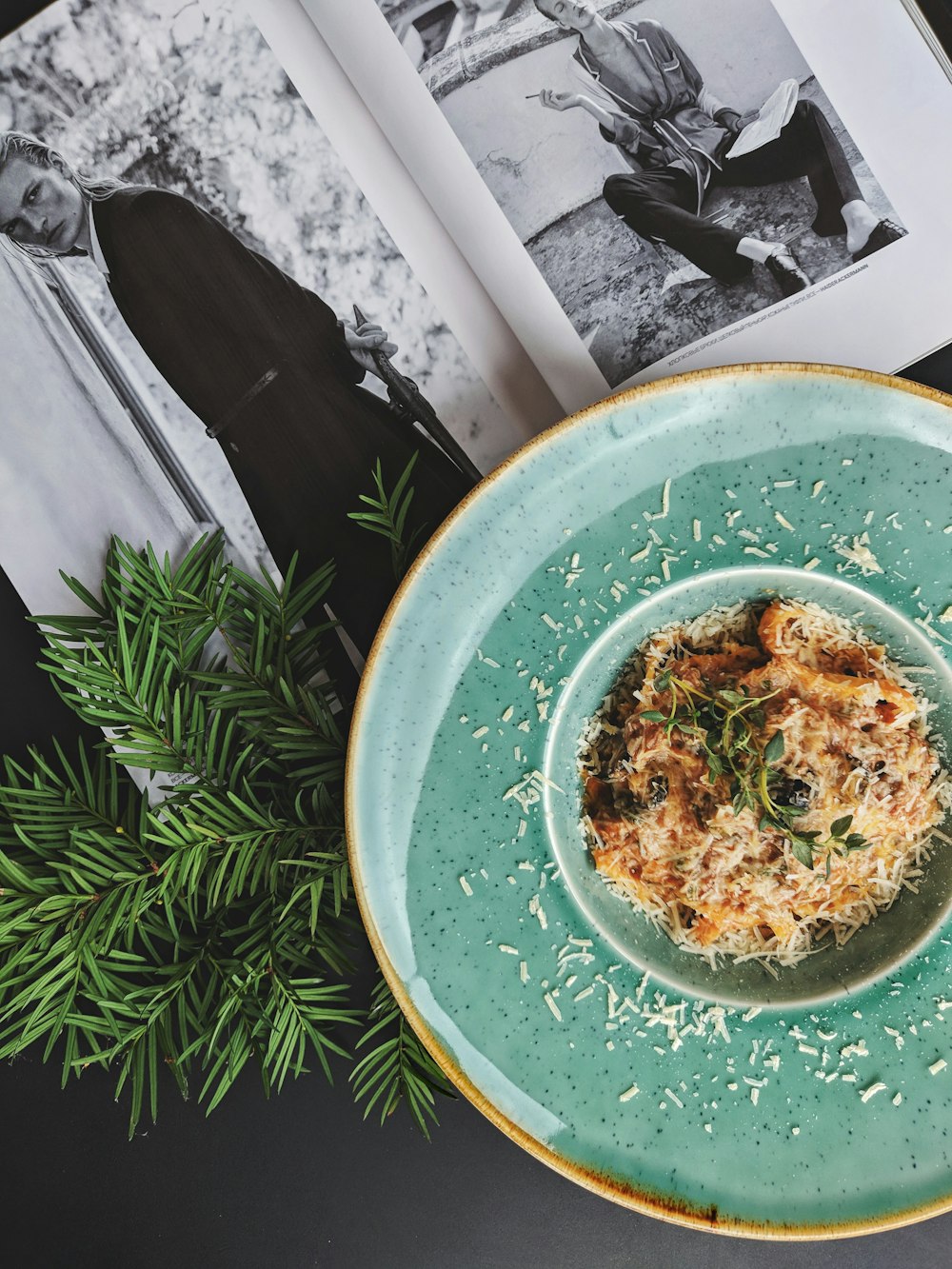 a plate of food on a table next to a book