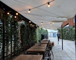 rectangular brown wooden dining inside white awning