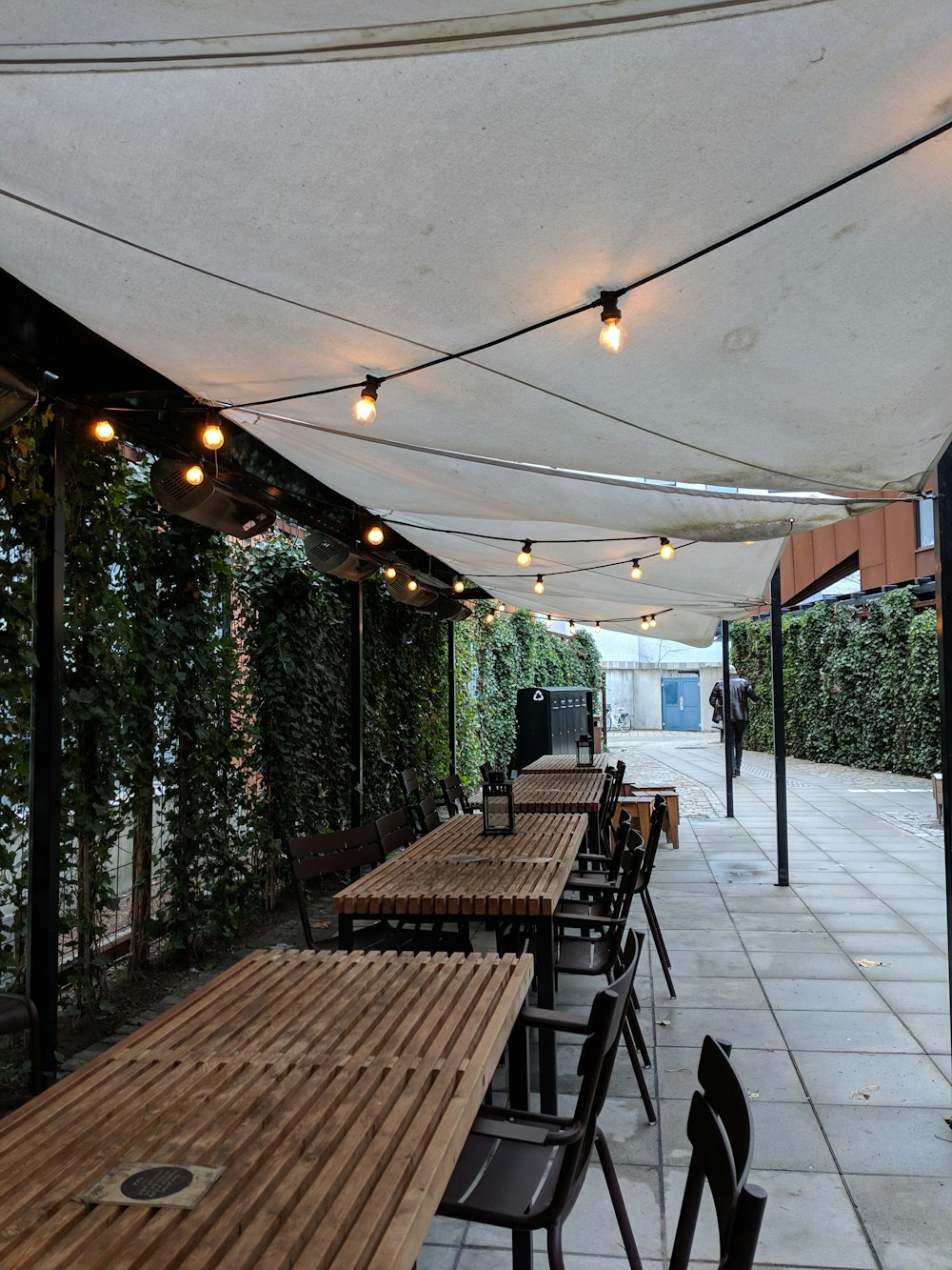 rectangular brown wooden dining inside white awning