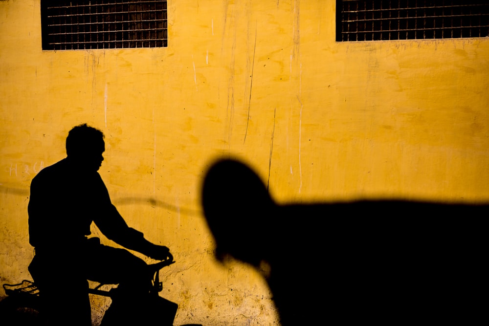 silhouette of man riding bicycle