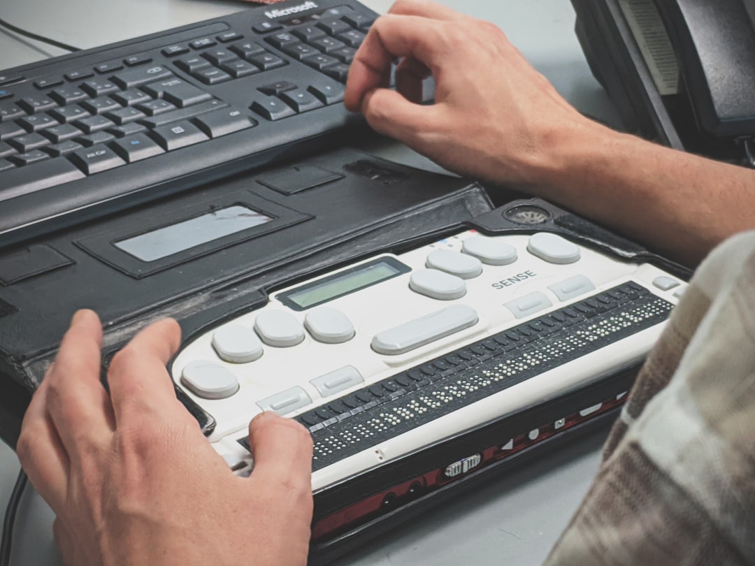person using braille writer, Blind man using a braille screen reader.