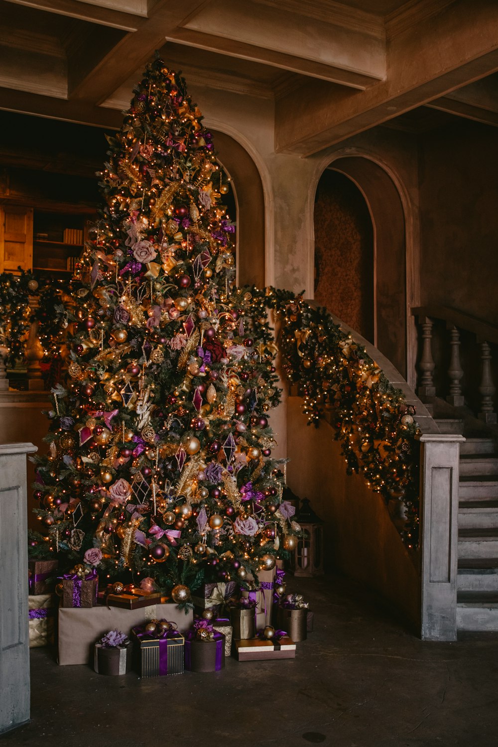 multicolored Christmas tree beside of stairs