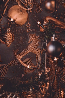 A close-up of a rider’s decorated helmet featuring a small nativity scene and festive red ribbons.