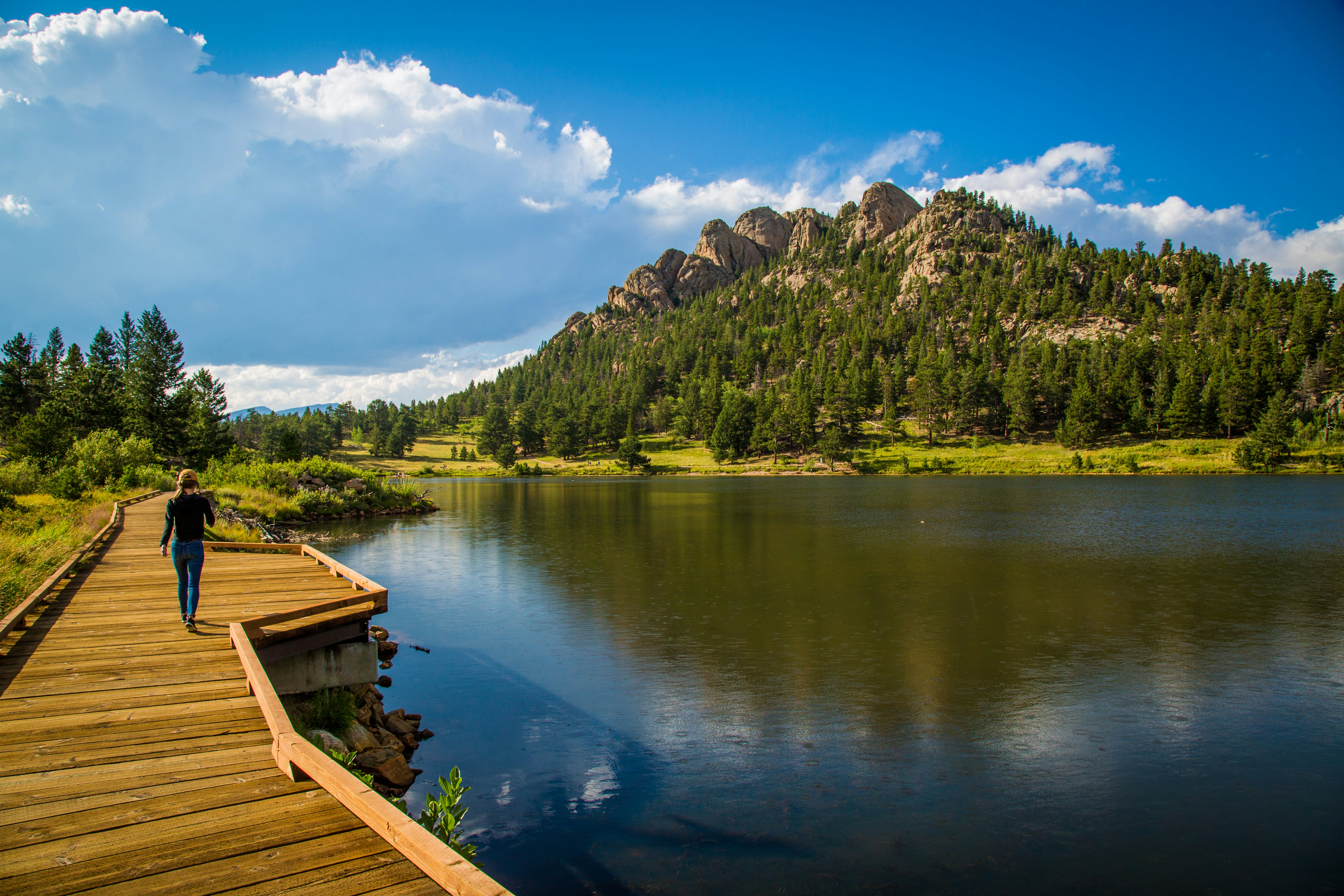 person walking beside body of water