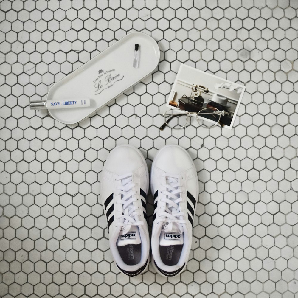 pair of white-and-black Adidas Superstar sneakers