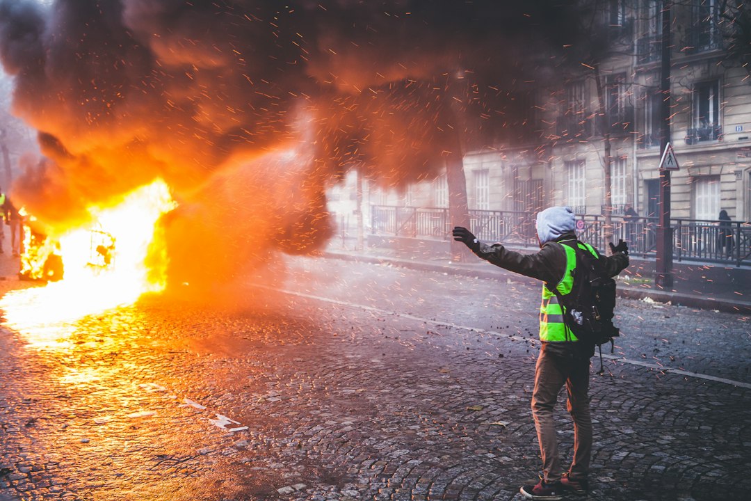 person standing beside fire during daytime