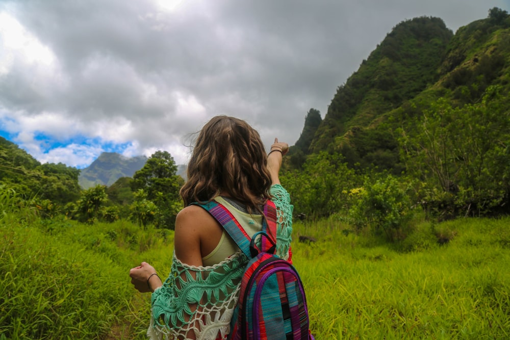 woman pointing at mountain