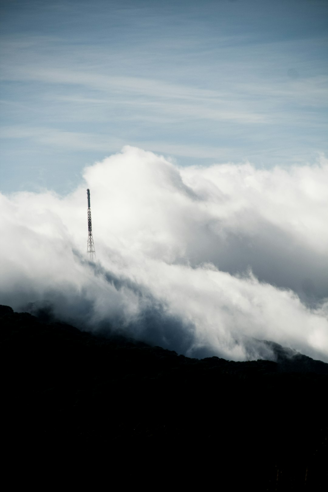 transmission tower with sea of clouds