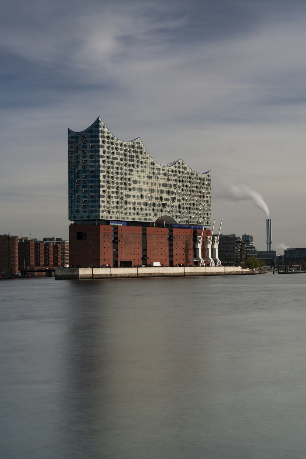 photography of brown and gray building beside body of water during daytime