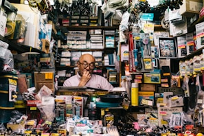 man standing beside assorted-color electronic and accessory packs