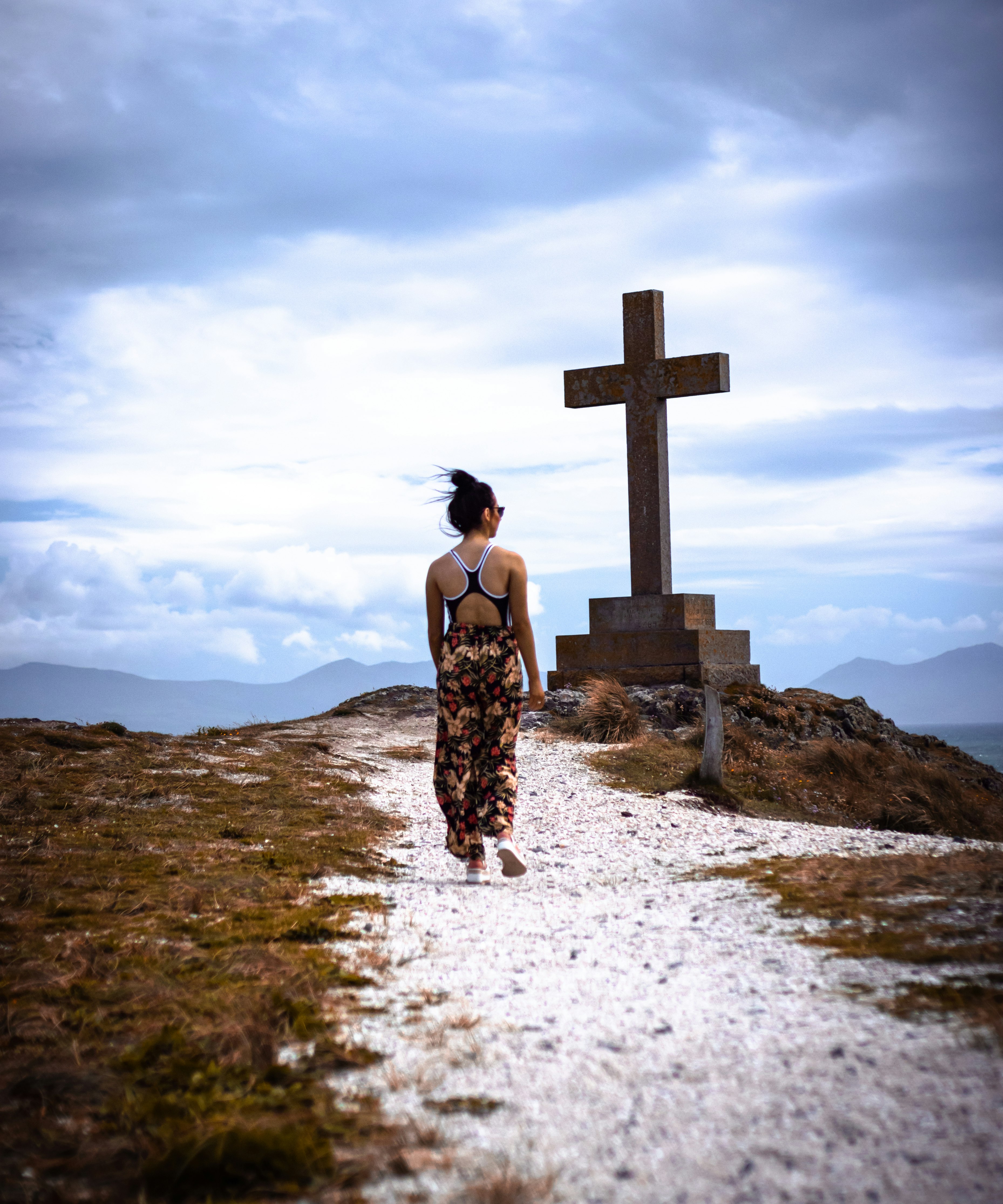 woman standing infront of cross statue