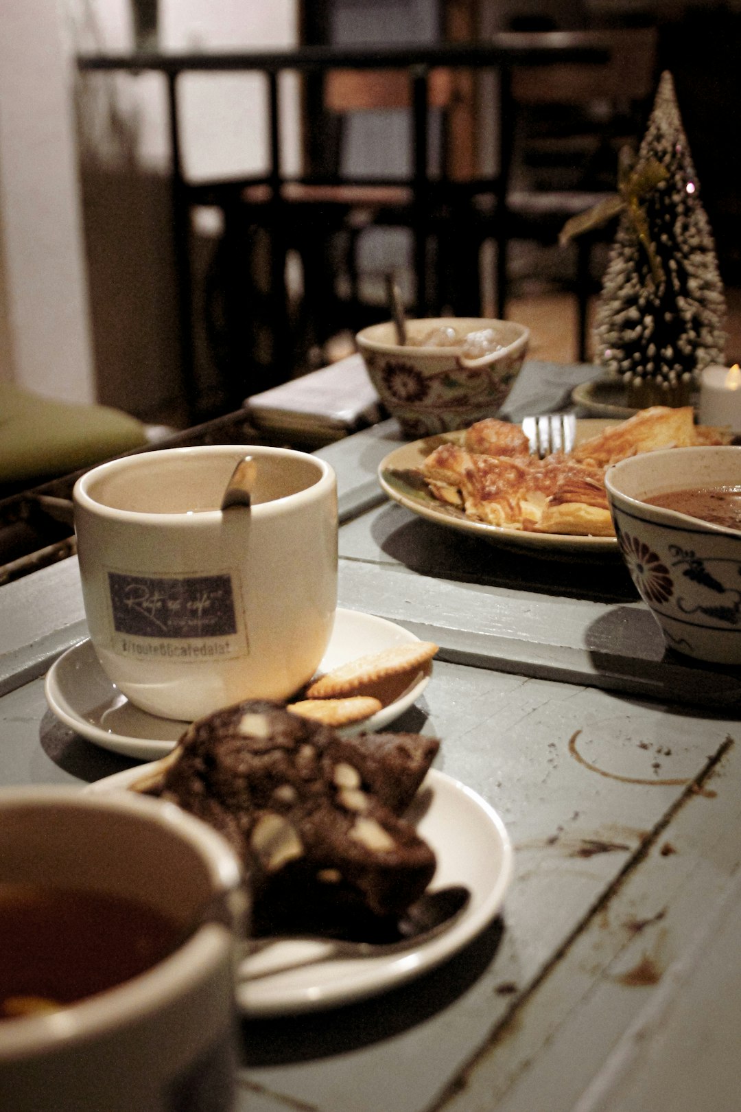 beige and black teacup on table