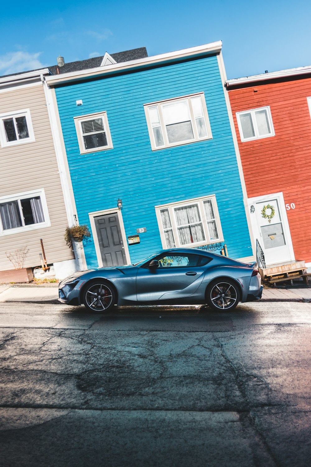 gray coupe beside house