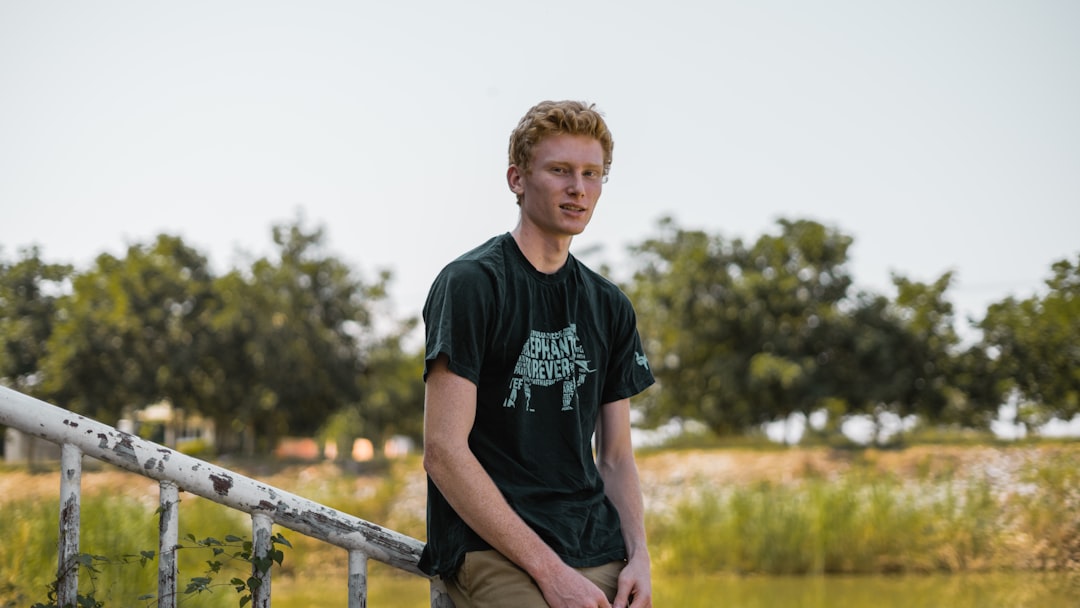 man wearing black and grey crew-neck t-shirt during daytime