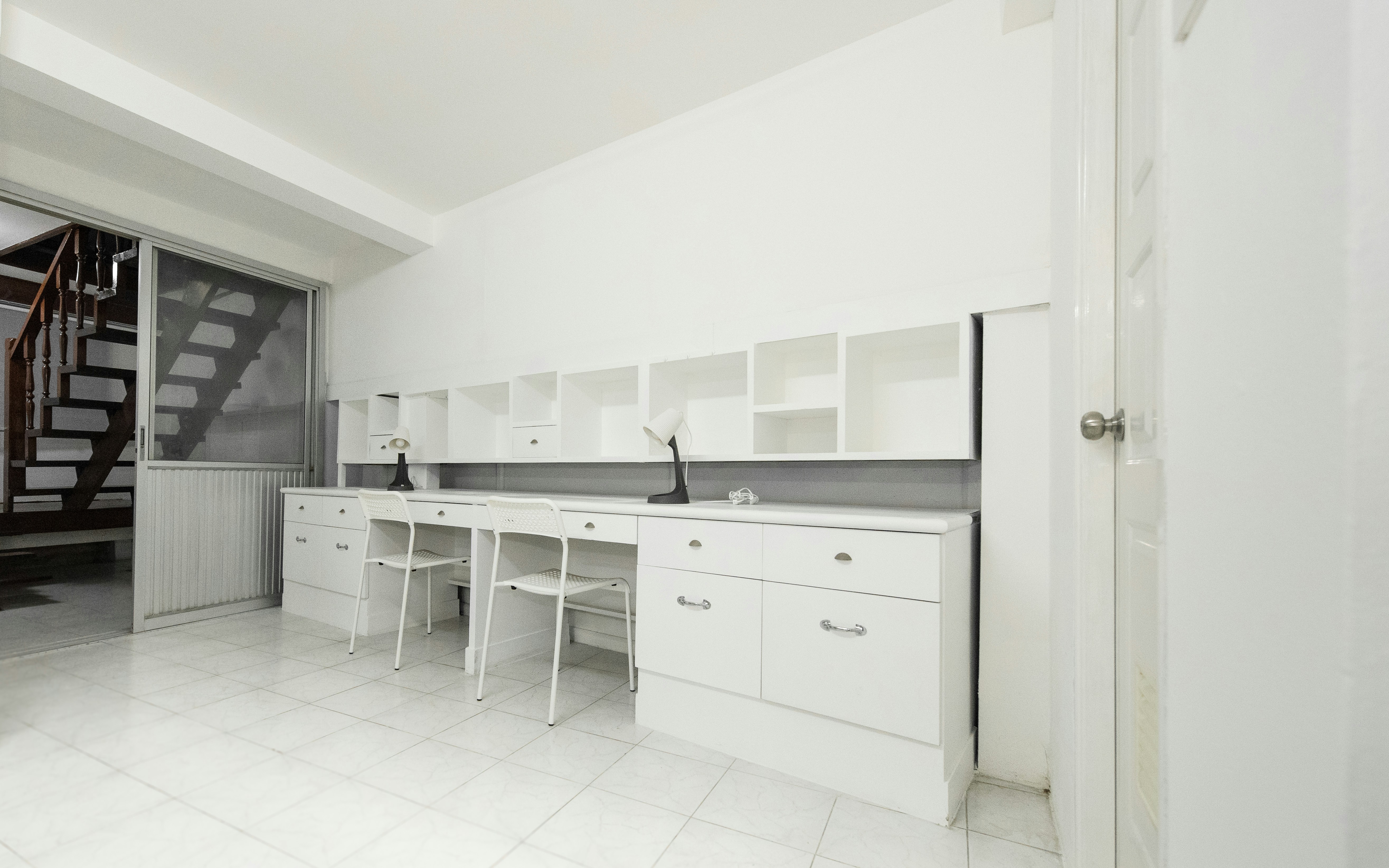 White desk with chairs and lamp