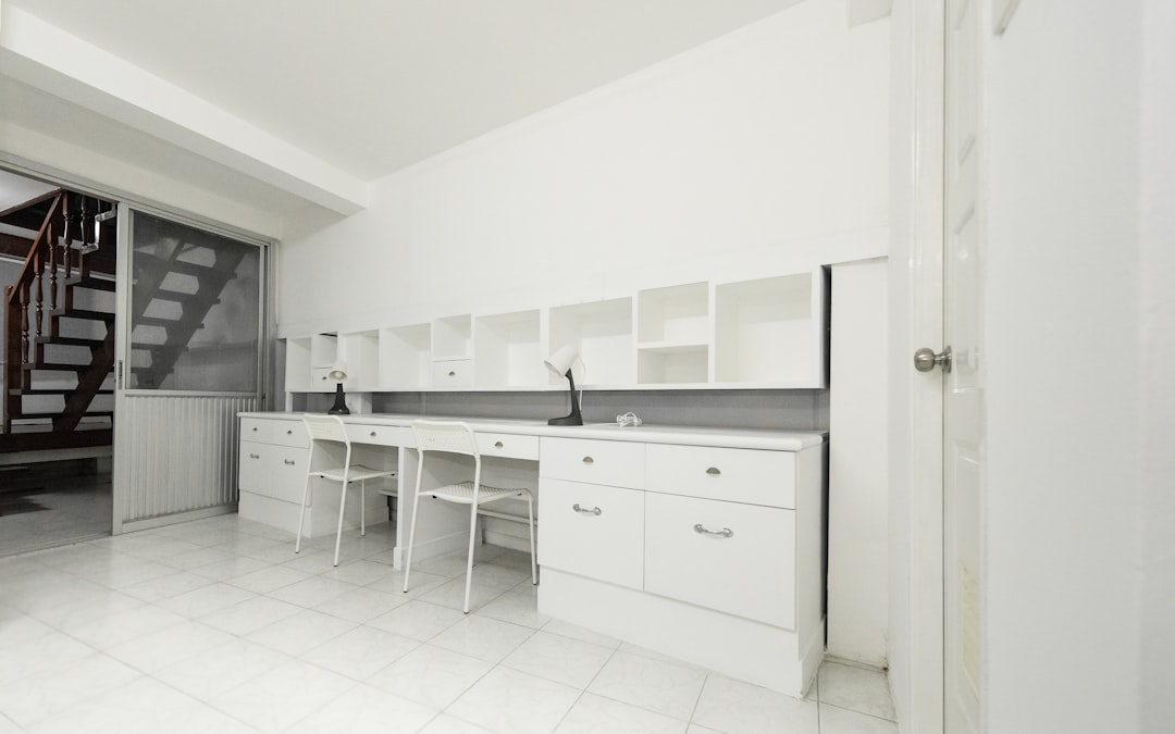 two chairs beside white wooden desk, White desk with chairs and lamp