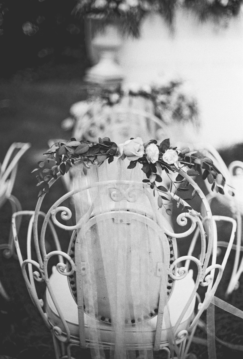 grayscale photography of chair with flowers