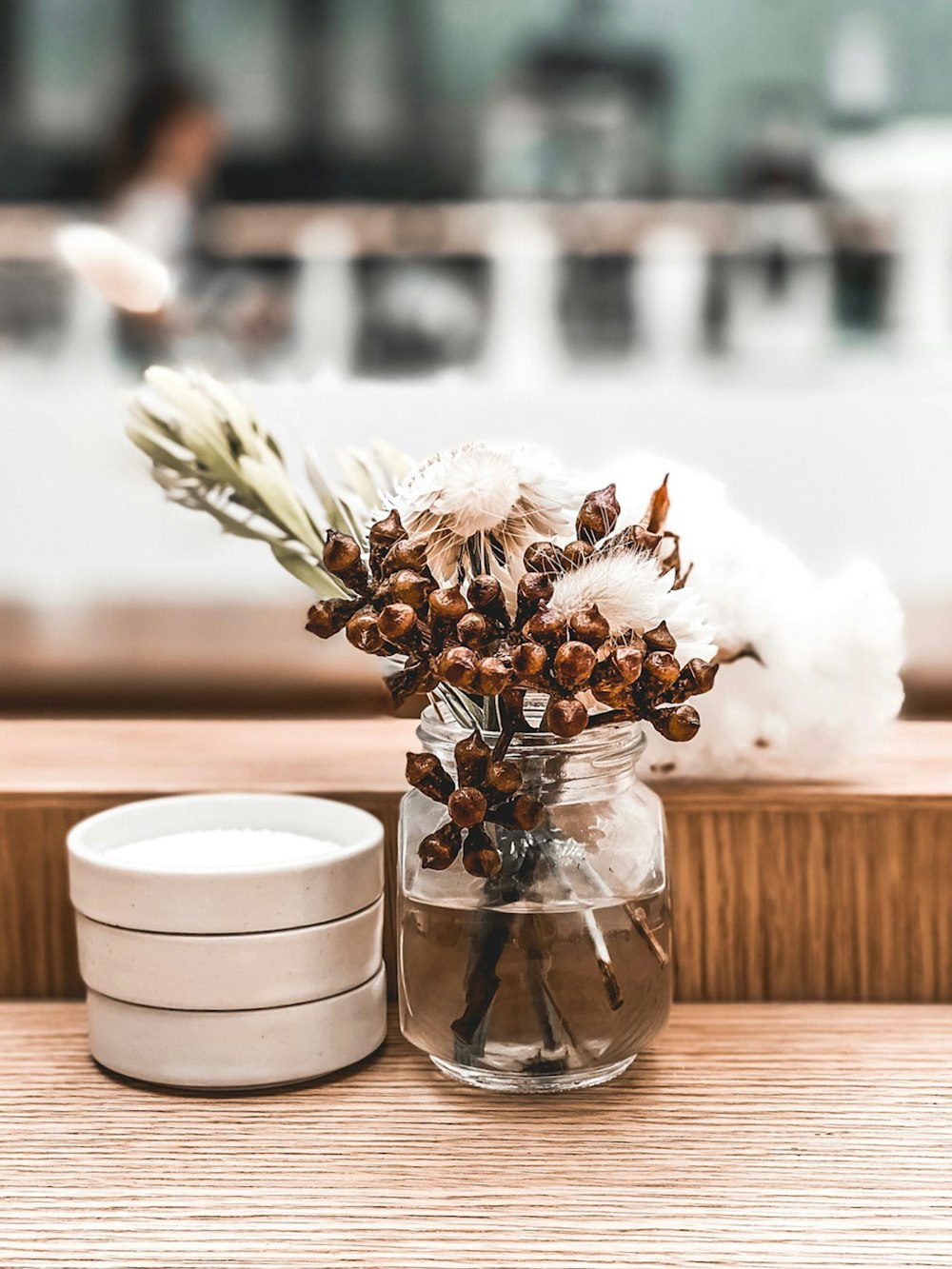 white-petaled flowers on clear jar