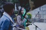 A journalist interviewing a community member in an outdoor setting.