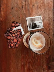 clear glass cup on brown table