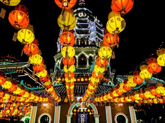 Front view of Xingnan Temple during a vibrant festival with lanterns and decorations