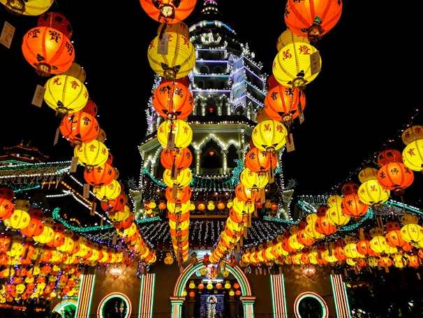 Front view of Xingnan Temple during a vibrant festival with lanterns and decorations