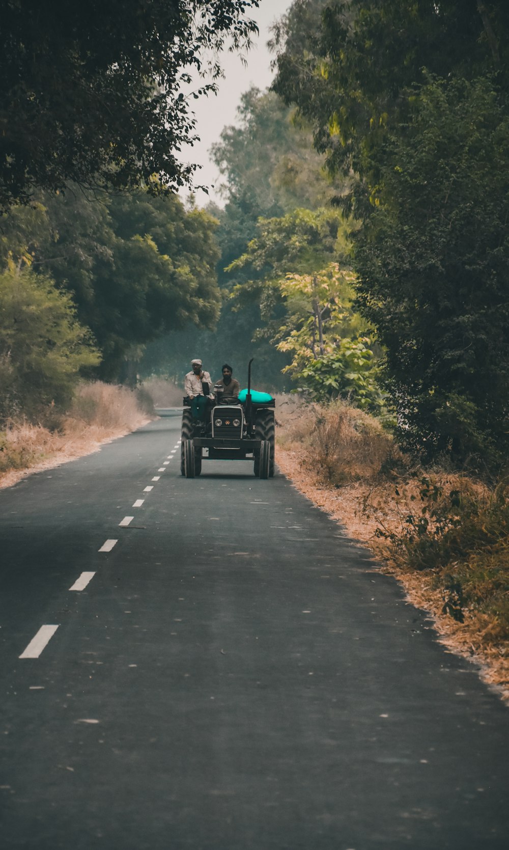 a couple of people riding on the back of a truck