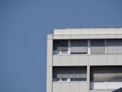 Finished commercial building exterior showcasing clean roofing and modern windows.