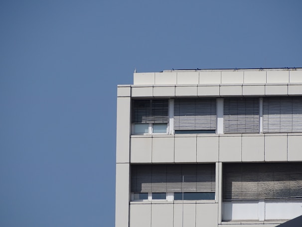 Wide shot of a commercial building showing exterior insulated panels installed on the facade under clear sky.
