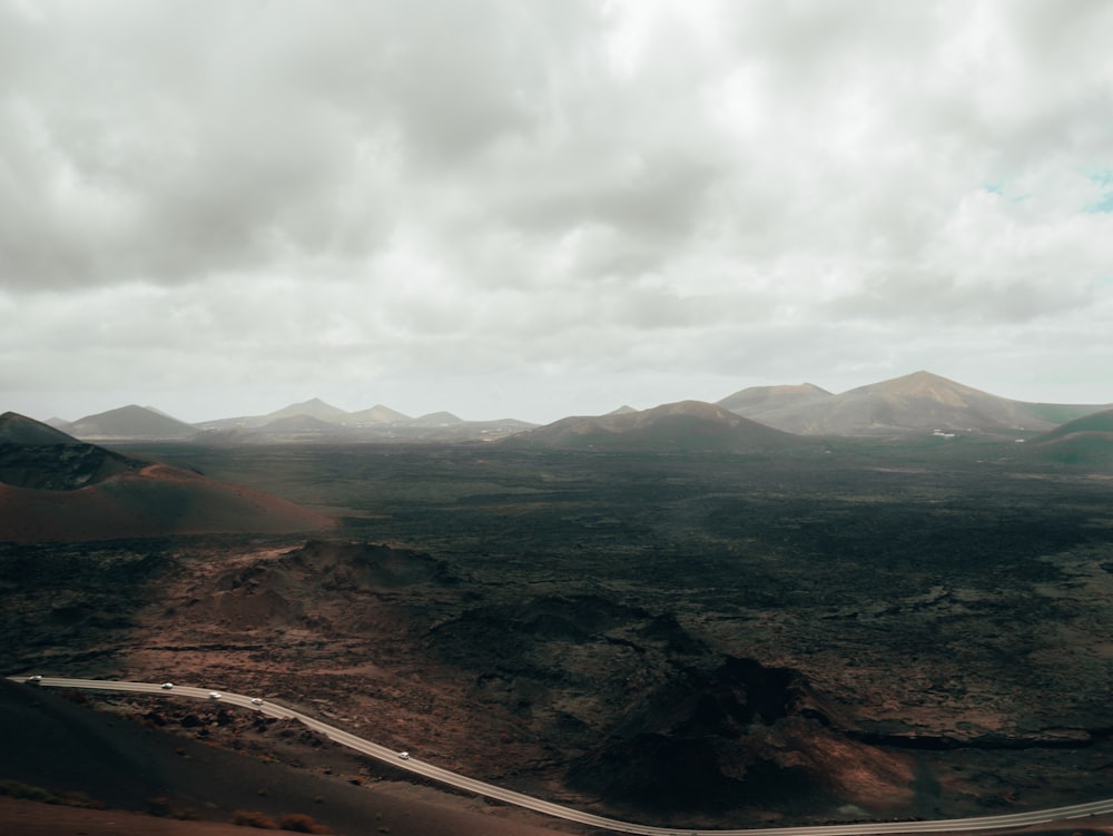 brown mountains and white clouds