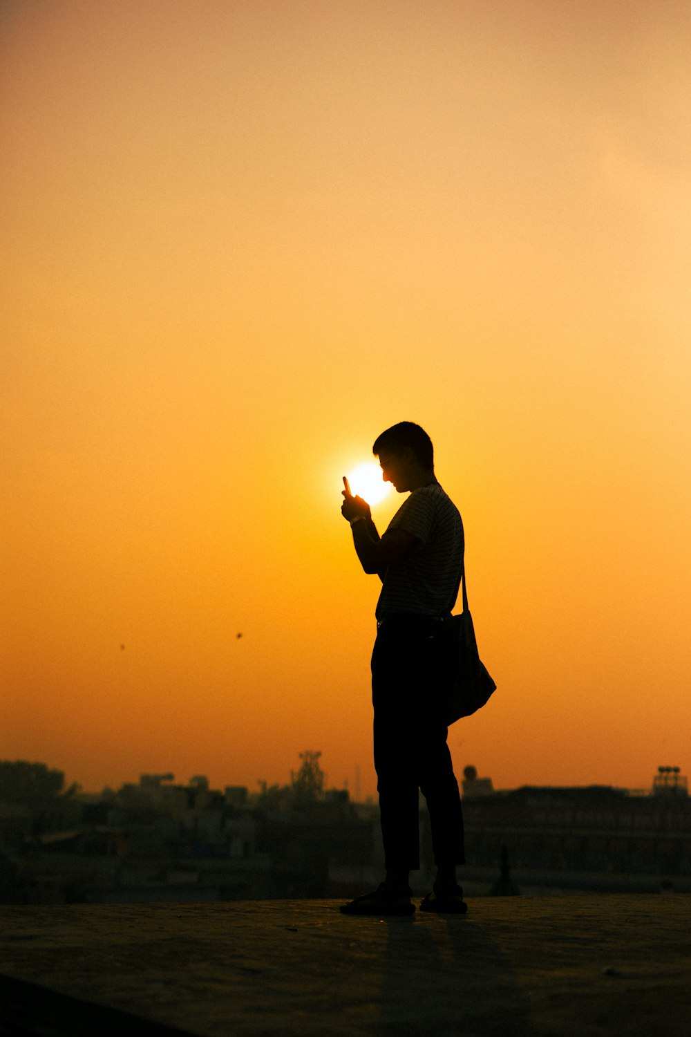 silhouette photo of man with bag