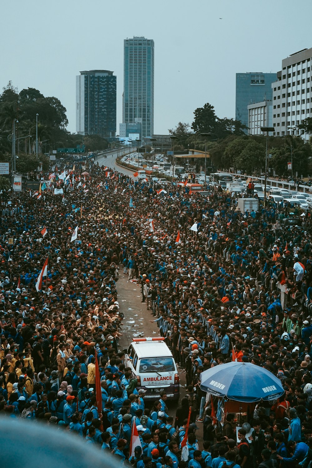 crowd standing on road during daytime