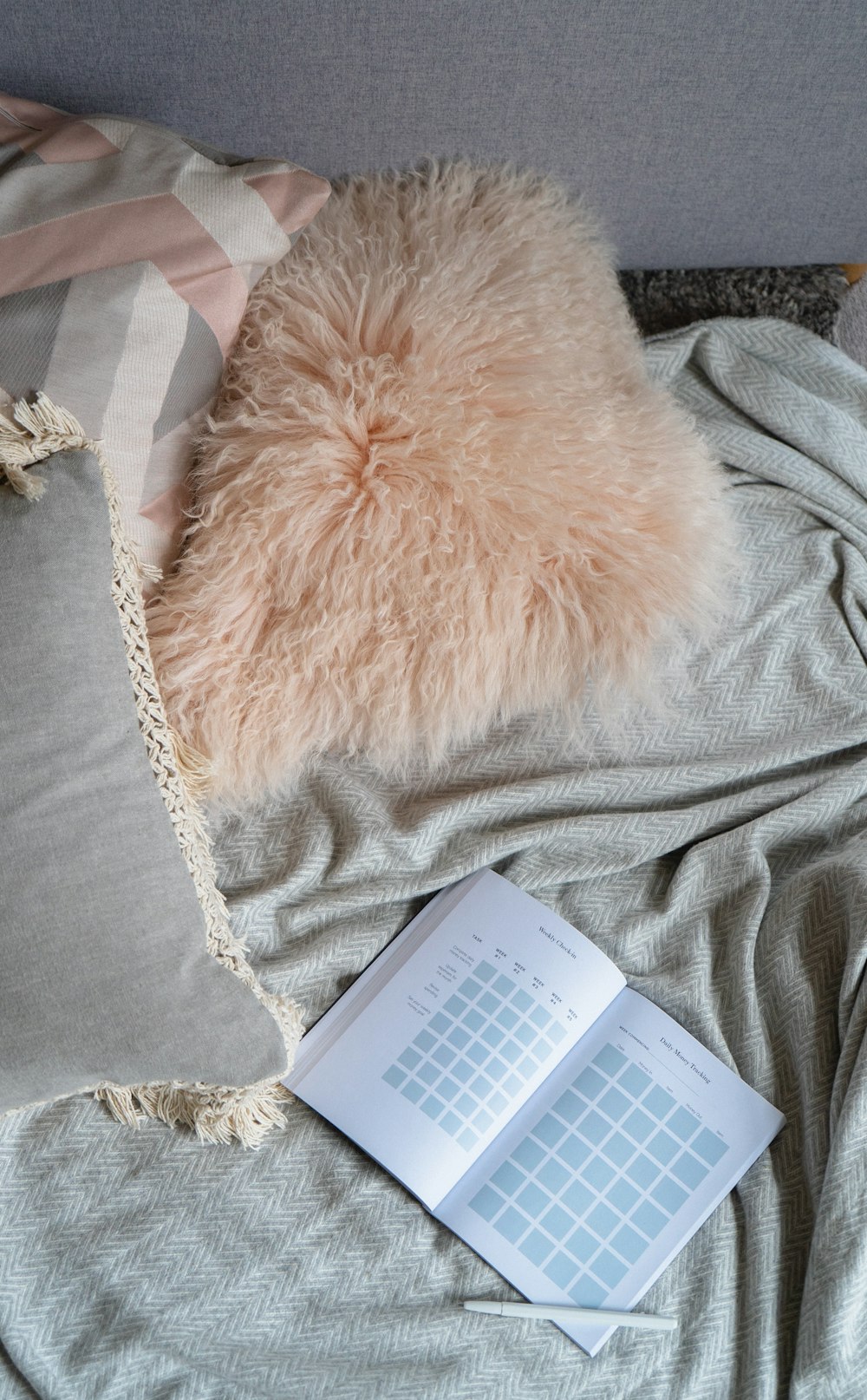 gray pillow and white books