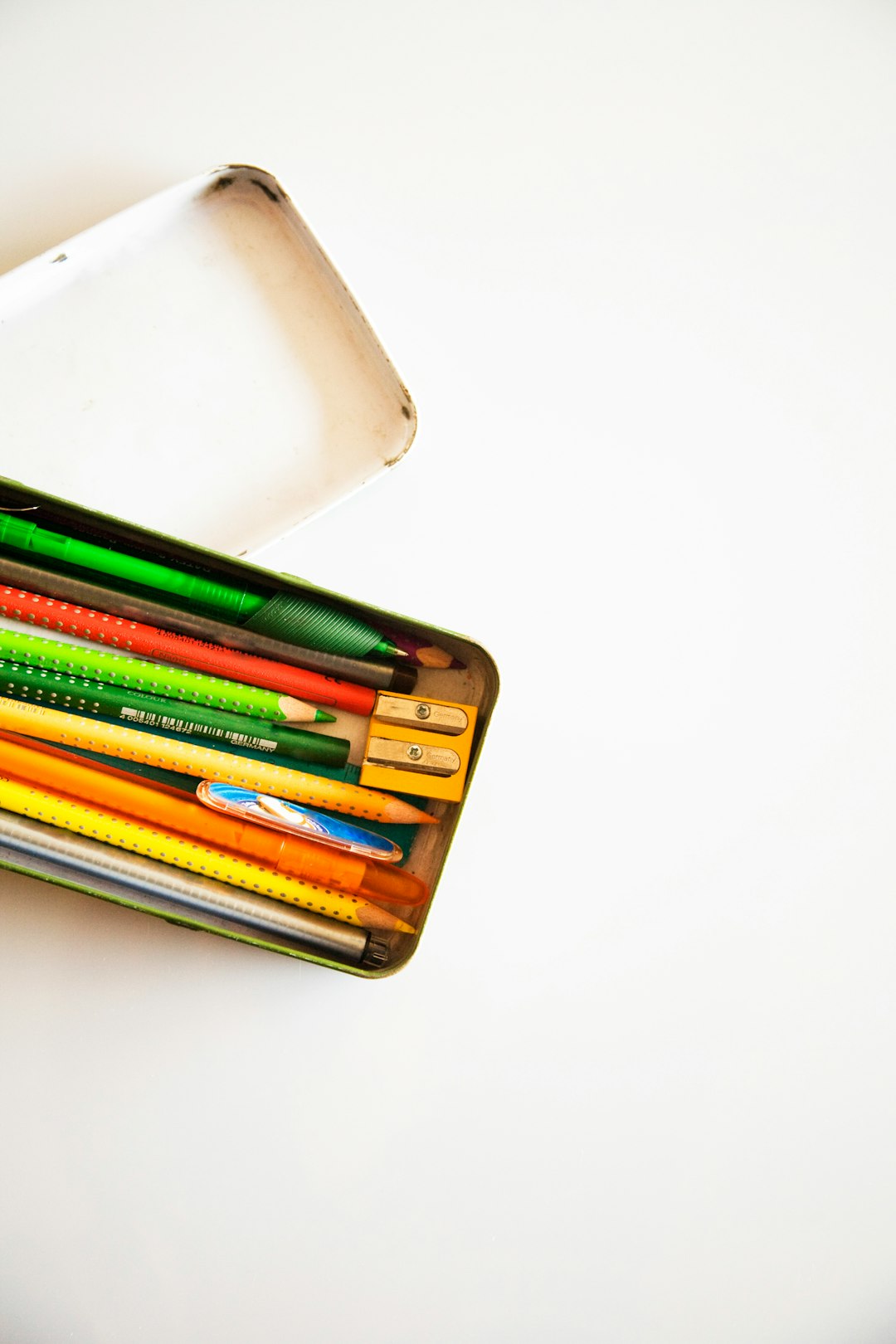 assorted-color pencil and pens inside pencil case