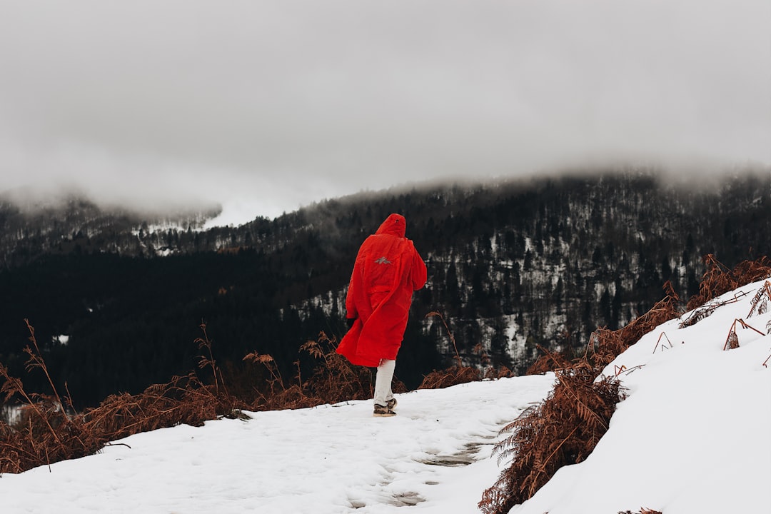 man in red hooded jacket